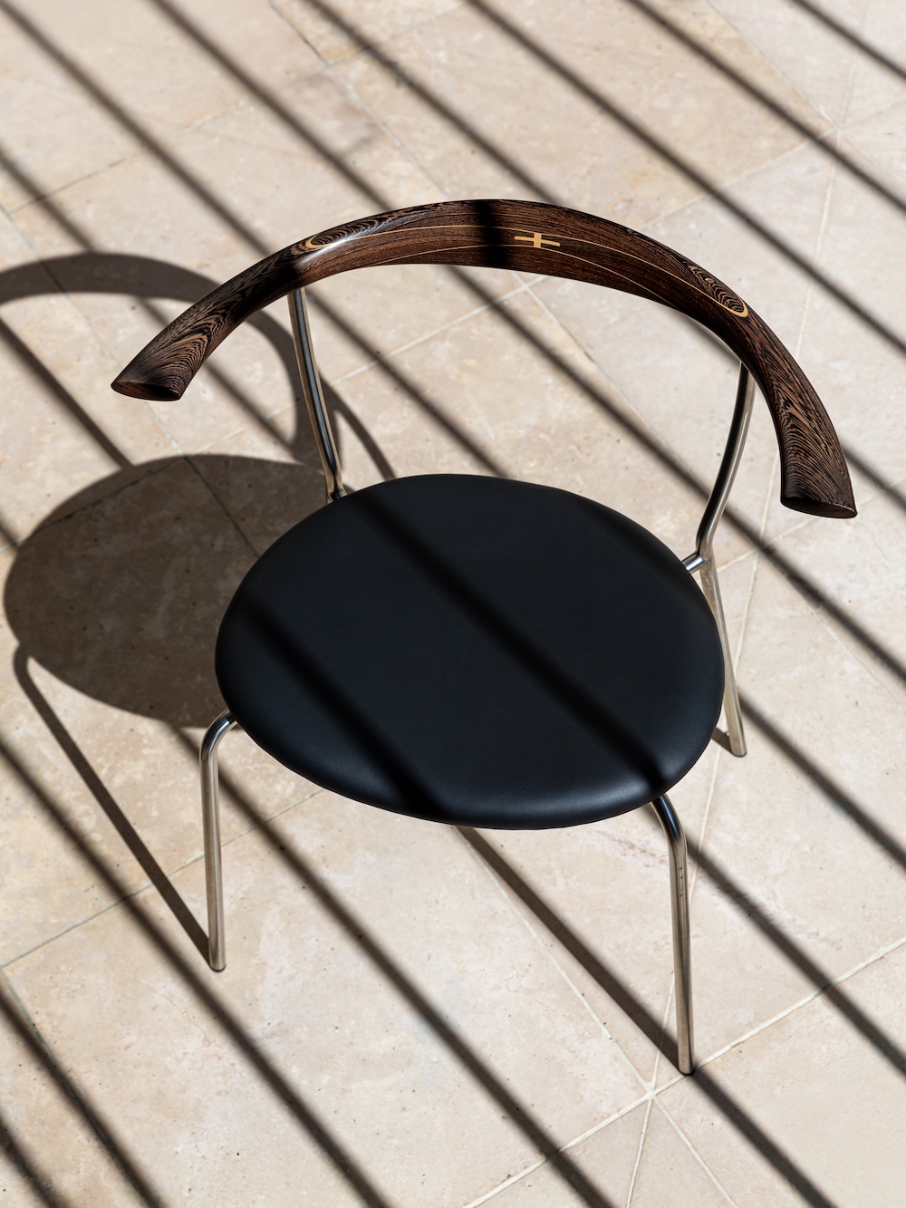 http://pp701%20Minimal%20Chair%20in%20wengé%20wood%20with%20black%20upholstered%20seat,%20designed%20by%20Hans%20J.%20Wegner%20and%20part%20of%20PP%20Møbler's%20Rare%20Editions.